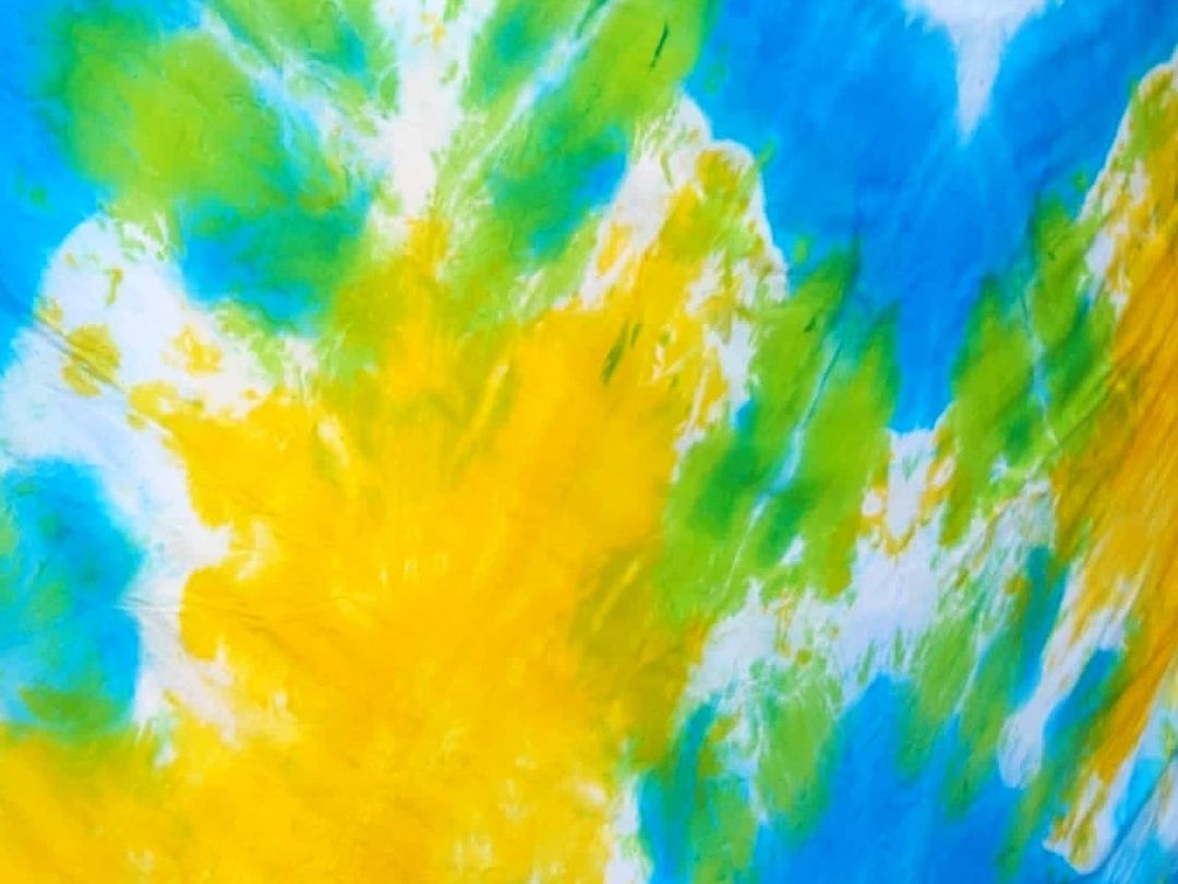 Close-up of tie & dye fabric in yellow, green and blue